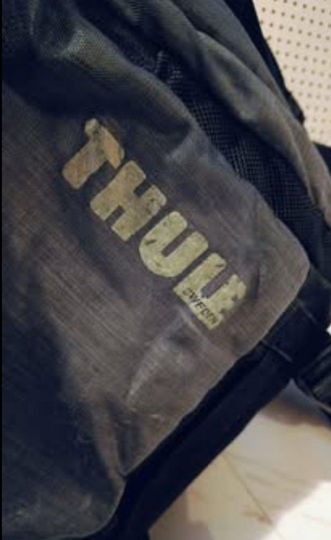 💯 THULE Stravan Daypack for 15" Laptop Backpack (Category: Backpacks) located in General Mariano Alvarez. Submitted by randzwurkz85264 (Listing ID 1427018065, Image 3). Description: Durable Thule backpack with multiple compartments and adjustable straps. Features a front pocket with a zipper and a main compartment with a blue lining. The back of the backpack has padded support for comfort. The Thule logo is visible on the front and side. Include