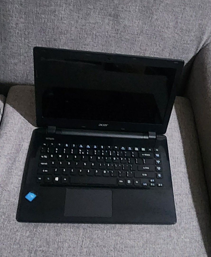Acer ES-411 Laptop (Category: Laptops & Notebooks) located in Quezon City. Submitted by sebbysprelovedgoods (Listing ID 1426974238, Image 1). Description: Acer ES-411 laptop with Intel processor. Includes the original charger. The laptop has stickers on the lid. The model number is ES-411-C3K3. Manufactured in 2014. The laptop has a black body and keyboard. The screen is open in the images. The laptop has a VGA port, Ethernet port, HDMI port, and