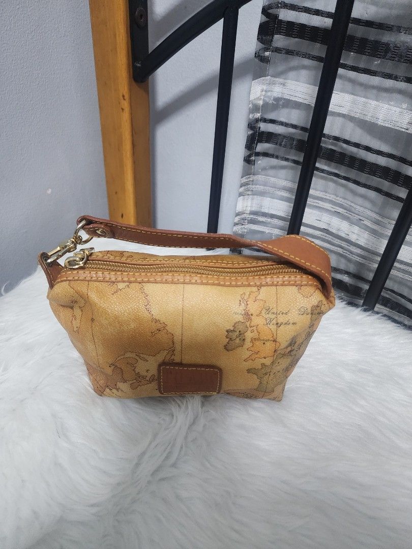 Alviero Martini Prima Classe Handbag (Category: Luxury Bags & Wallets) located in Paranaque City. Submitted by rizasauthenticitems (Listing ID 1427149266, Image 1). Description: Alviero Martini pouch features a classic Geo Map print. Leather handle and zipper closure. The interior is a light brown color. The hardware is gold-toned..