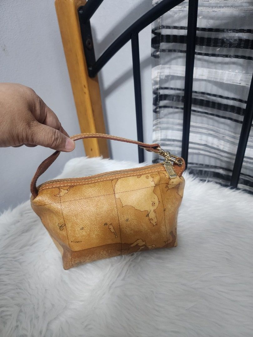 Alviero Martini Prima Classe Handbag (Category: Luxury Bags & Wallets) located in Paranaque City. Submitted by rizasauthenticitems (Listing ID 1427149266, Image 2). Description: Alviero Martini pouch features a classic Geo Map print. Leather handle and zipper closure. The interior is a light brown color. The hardware is gold-toned..