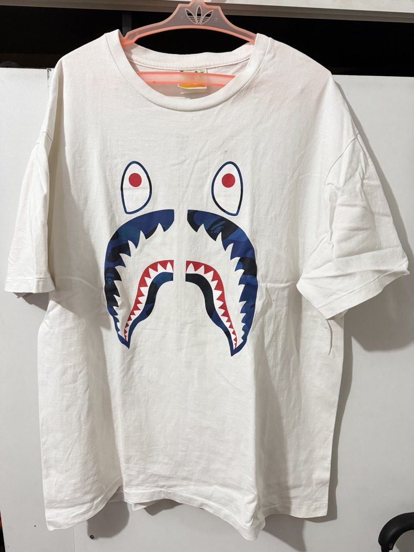 Bape blue camo shark tee XL (Category: Tshirts & Polo Shirts ) located in Mandaluyong City. Submitted by snowreinbolt (Listing ID 1427112382, Image 1). Description: Bape blue camo shark tee XL on tag 22x28 Excellent condition No gold tag Mandaluyong location Lalamove/j&t shipping 1299.
