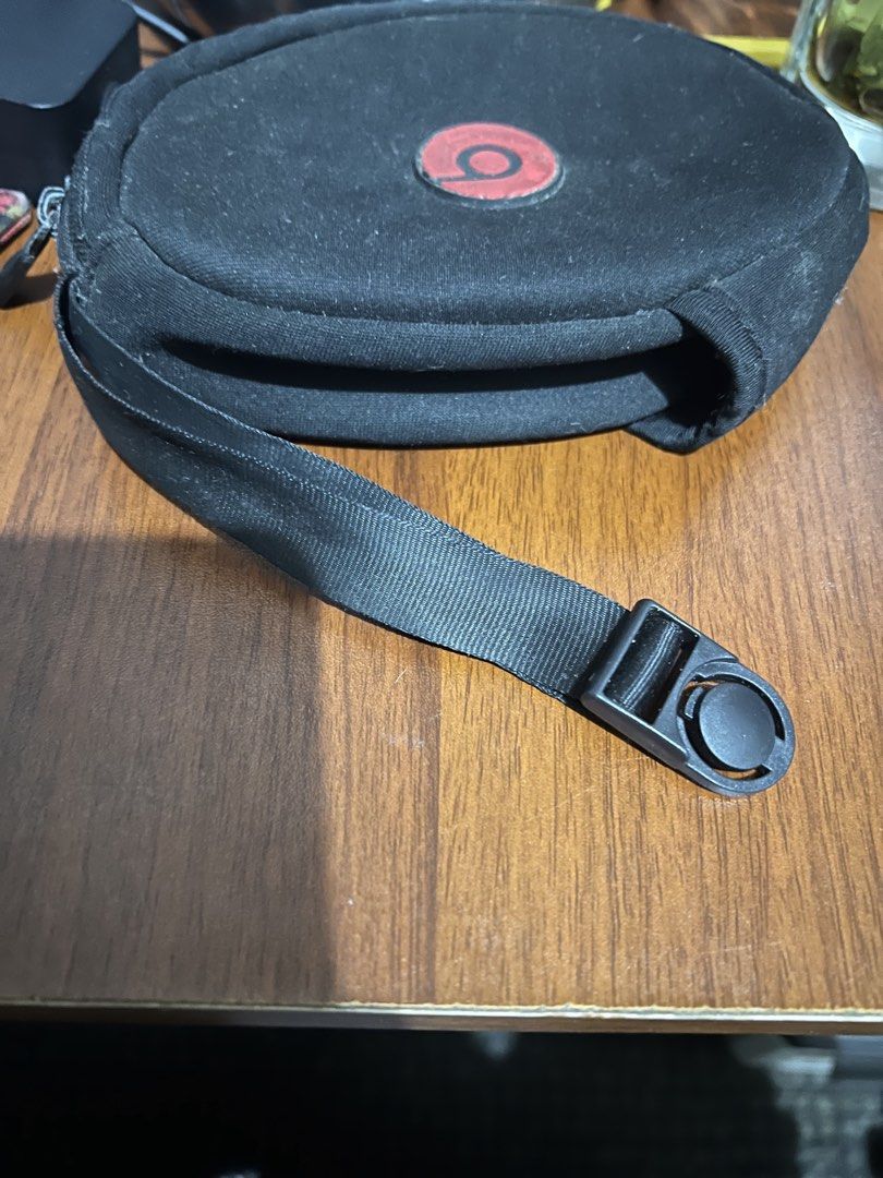 Beats Headphone soft Case (Category: Headphones & Headsets) located in Paranaque City. Submitted by ekkostarfall.12902 (Listing ID 1427117546, Image 3). Description: - well used but not abused - Black headphone case with a red Beats logo - chipped paint on zipper closure and a carrying strap with a buckle MOP: Maya, GCash SF shouldered by buyer Location: Parañaque.