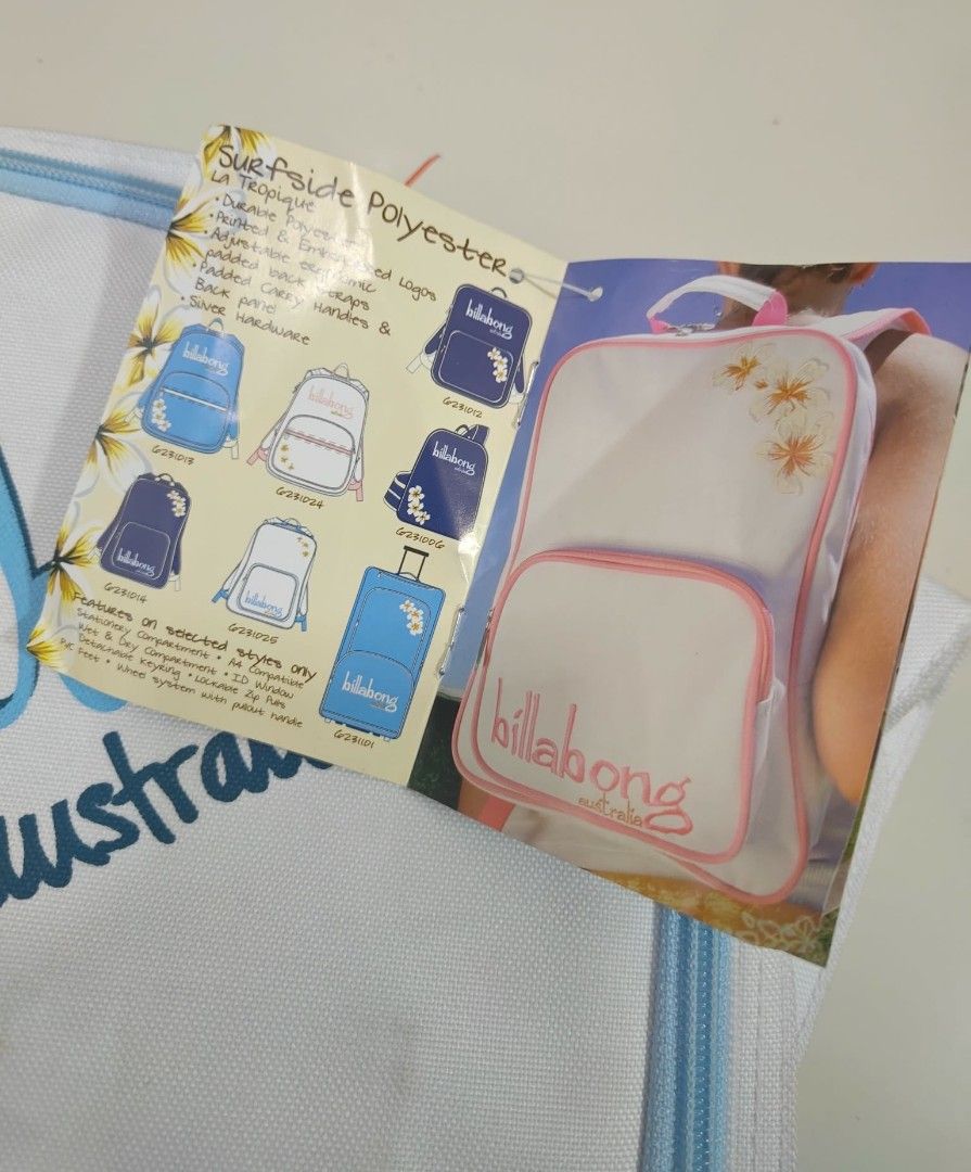 Billabong Australia Surfside Polyester Backpack (Category: Backpacks) located in Naga. Submitted by princessta62477 (Listing ID 1427082586, Image 3). Description: Billabong backpack features a white exterior with blue accents and a hibiscus flower design. It includes a zipper closure and a tag. The backpack is made of Surfside Polyester. The design includes the Billabong Australia logo. The backpack has a shoulder strap with the Billabong logo an