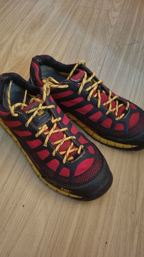 Caterpillar (CAT) Sneakers (Category: Sneakers) located in Manila. Submitted by watchfanatic14 (Listing ID 1427016397, Image 1). Description: Caterpillar (CAT) sneakers with a red and black design. Features yellow laces and a yellow sole. The CAT logo is visible on the tongue of the shoe..