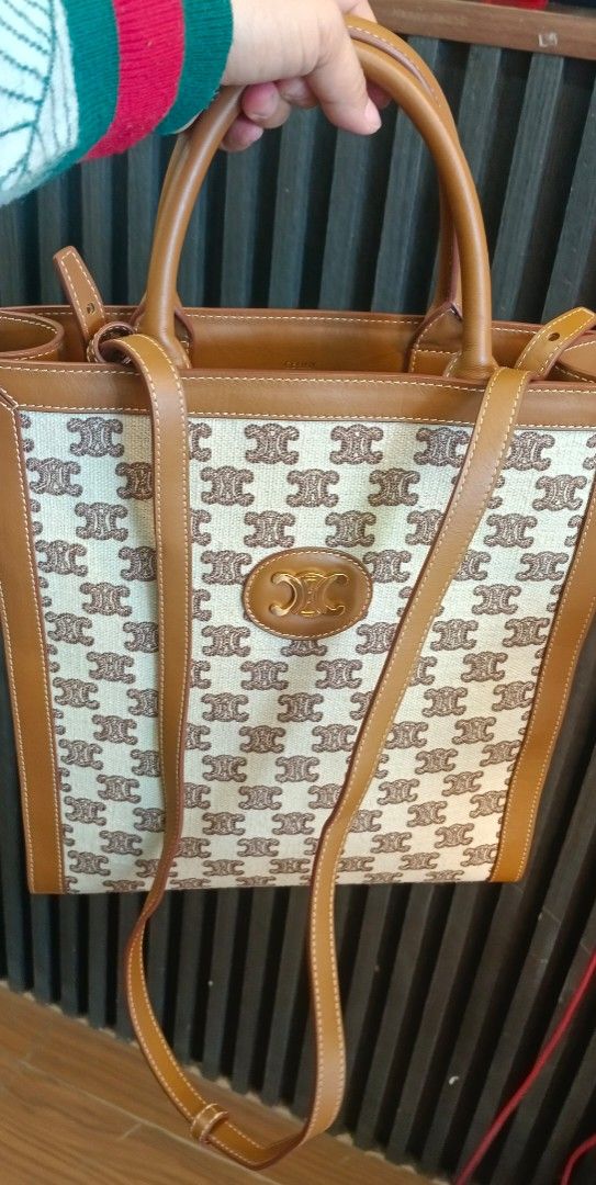 Celine Tote Bag (Category: Luxury Bags & Wallets) located in Legazpi City. Submitted by georgepineda791 (Listing ID 1427089199, Image 1). Description: Celine tote bag with a monogram pattern. Features a top handle and a detachable shoulder strap. The bag has a brown leather trim and a beige canvas body. The interior is lined with leather and includes the Celine Paris logo. The bag has a rectangular shape..