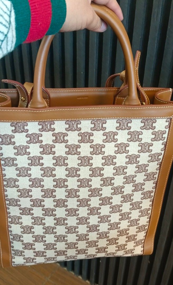 Celine Tote Bag (Category: Luxury Bags & Wallets) located in Legazpi City. Submitted by georgepineda791 (Listing ID 1427089199, Image 2). Description: Celine tote bag with a monogram pattern. Features a top handle and a detachable shoulder strap. The bag has a brown leather trim and a beige canvas body. The interior is lined with leather and includes the Celine Paris logo. The bag has a rectangular shape..