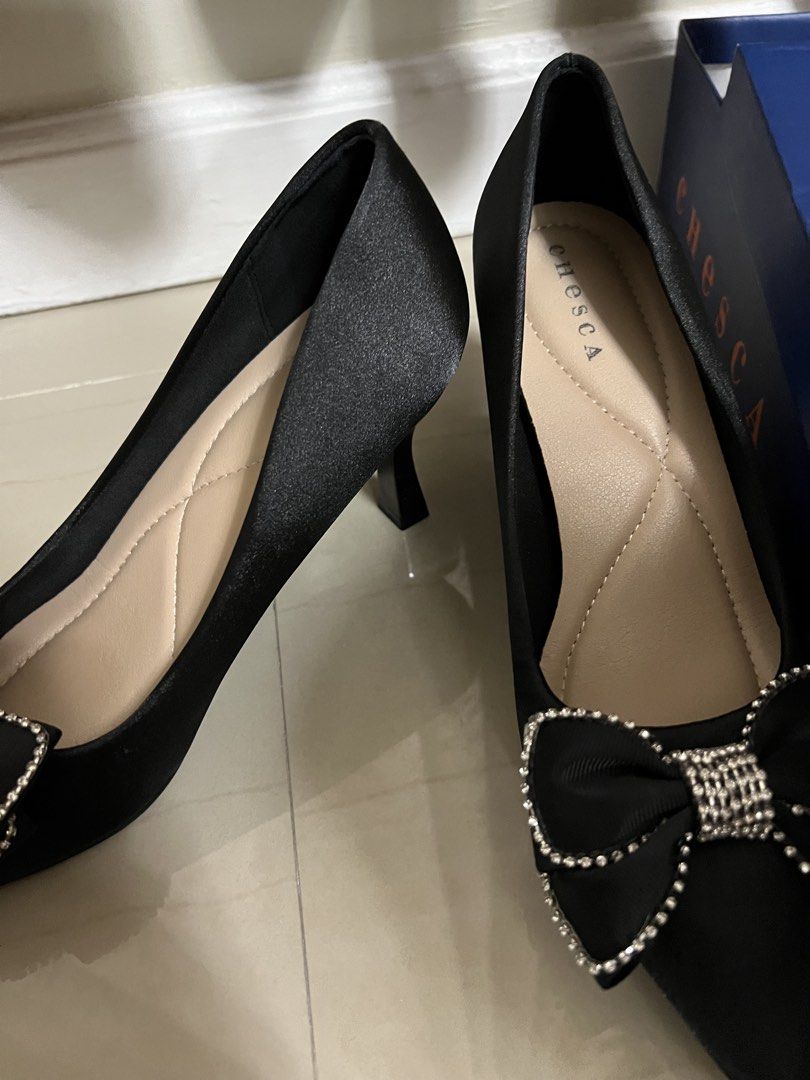 Cheska Black Heels with Bow (Category: Heels) located in Manila. Submitted by cluttercrushers (Listing ID 1427094170, Image 3). Description: Elegant black heels from Cheska. Features a pointed toe design with a decorative bow embellished with rhinestones. The heels have a moderate height and come with the original box. Size 40, as indicated on the sole. Used only once, bought from MOA.