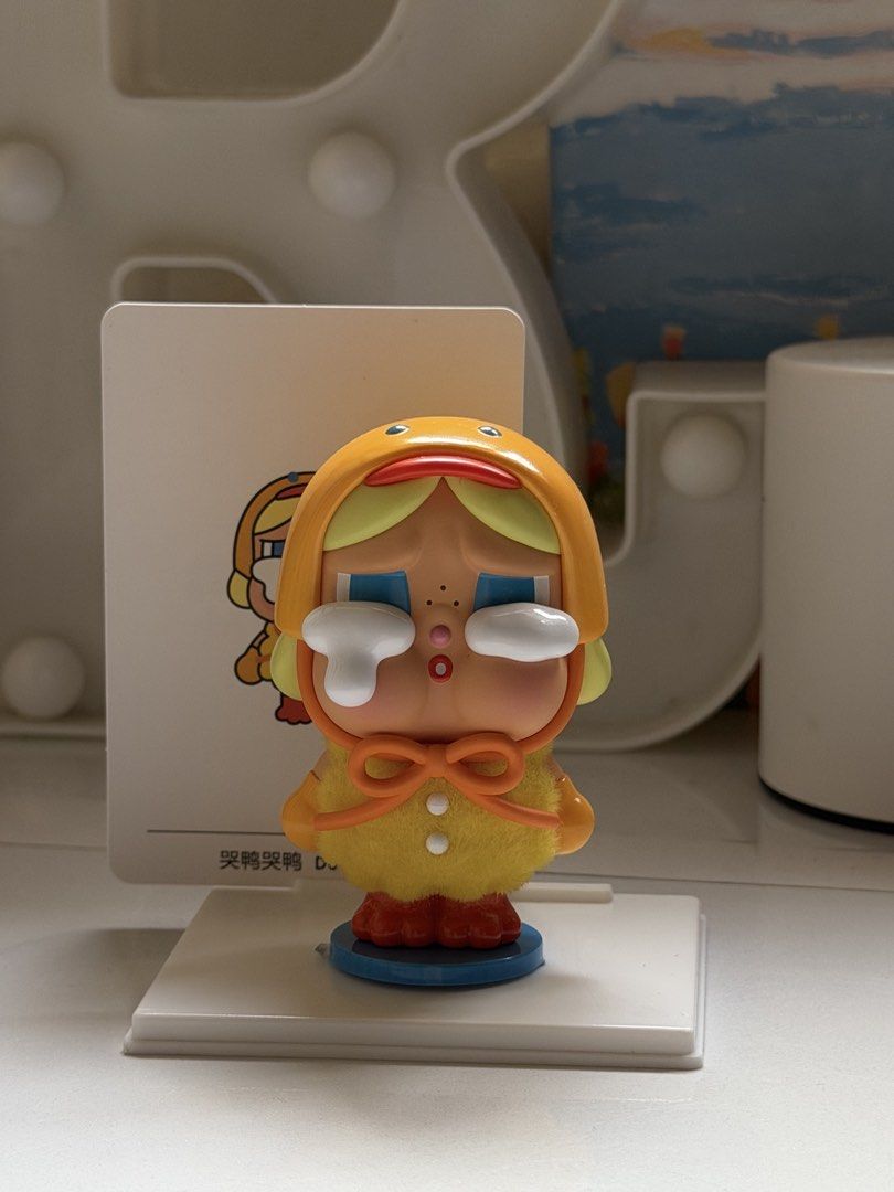 Crybaby Duck You Figurine (Category: Designer & Blind Box Toys) located in San Fernando. Submitted by aircatz (Listing ID 1426963230, Image 3). Description: Adorable Crybaby figurine features a duck-themed design. It has a yellow outfit with a matching hood and a bow. The figurine is displayed with a card that has the same design. It is a cute collectible item that would be a great addition to any collection. RFS: discont. Collection With box and