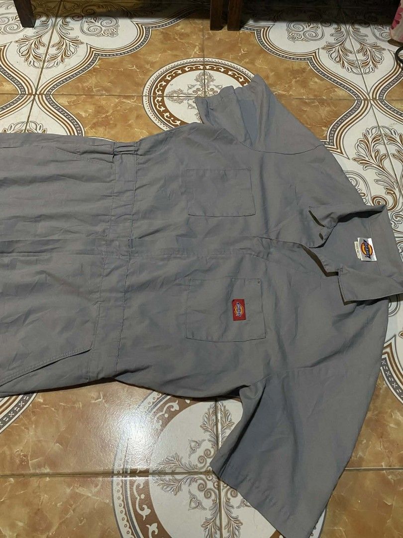 Dickies Gray Coverall (Category: Coats, Jackets and Outerwear) located in Hilongos. Submitted by tripnimobe-1 (Listing ID 1426988997, Image 2). Description: Gray Dickies coverall. Features short sleeves, multiple pockets, and a zipper closure. Includes the Dickies logo patch on the chest and a small red logo on the pocket..