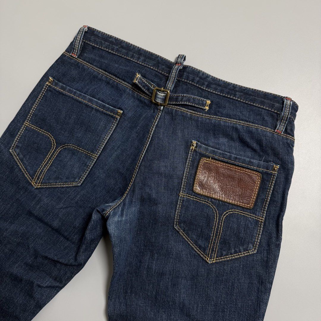 Dsquared2 Jeans Cinch back (Category: Jeans) located in Cebu City. Submitted by inukaybyjlf (Listing ID 1427031451, Image 2). Description: Actual measurements are shown in the photos. Authentic Dsquared2 jeans in size 44. Features a unique buckle detail on the back and a leather patch. Made in Italy. The jeans have a classic five-pocket design with a zip fly. The stitching is a mix of yellow and red. The jeans have a straight leg cut..