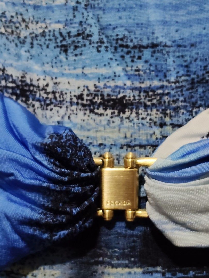 Escada Blue Print Dress (Category: Dresses) located in Manila. Submitted by audrey03 (Listing ID 1427133226, Image 3). Description: Elegant Escada dress featuring a unique blue print design. It has a cowl neckline and short sleeves. The dress is cinched at the waist with a gold-tone buckle. The dress has a knee-length hemline. The back of the dress has a similar print design..