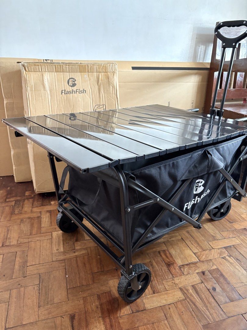 FlashFish Folding Wagon Cart with Table (Category: Storage Boxes & Baskets) located in Las Pinas. Submitted by phamyyy15 (Listing ID 1427027052, Image 1). Description: FlashFish folding utility cart is perfect for outdoor activities. It features a black frame and a black fabric basket. The cart has a foldable design for easy storage and transport. It also includes a table top. The cart has wheels for easy maneuverability..