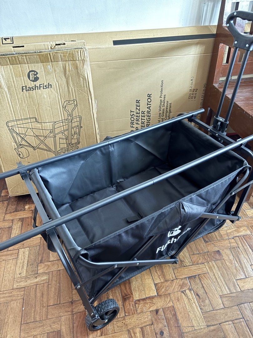 FlashFish Folding Wagon Cart with Table (Category: Storage Boxes & Baskets) located in Las Pinas. Submitted by phamyyy15 (Listing ID 1427027052, Image 2). Description: FlashFish folding utility cart is perfect for outdoor activities. It features a black frame and a black fabric basket. The cart has a foldable design for easy storage and transport. It also includes a table top. The cart has wheels for easy maneuverability..