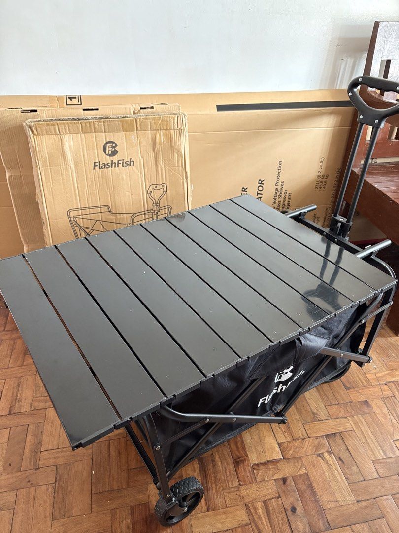 FlashFish Folding Wagon Cart with Table (Category: Storage Boxes & Baskets) located in Las Pinas. Submitted by phamyyy15 (Listing ID 1427027052, Image 3). Description: FlashFish folding utility cart is perfect for outdoor activities. It features a black frame and a black fabric basket. The cart has a foldable design for easy storage and transport. It also includes a table top. The cart has wheels for easy maneuverability..