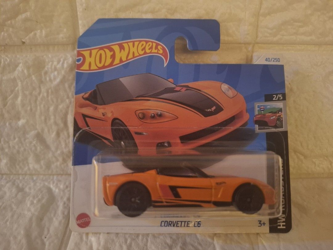 Hot Wheels Corvette C6 (Category: Vehicle & Diecast Models) located in Narvacan. Submitted by jigger85_2ndaccount (Listing ID 1426975739, Image 1). Description: Hot Wheels Corvette C6 diecast car. It is orange with black accents. The car is still in its original packaging. The packaging includes the Hot Wheels logo and the Corvette C6 model name. It is part of the 40/250 series and is marked as 2/5..