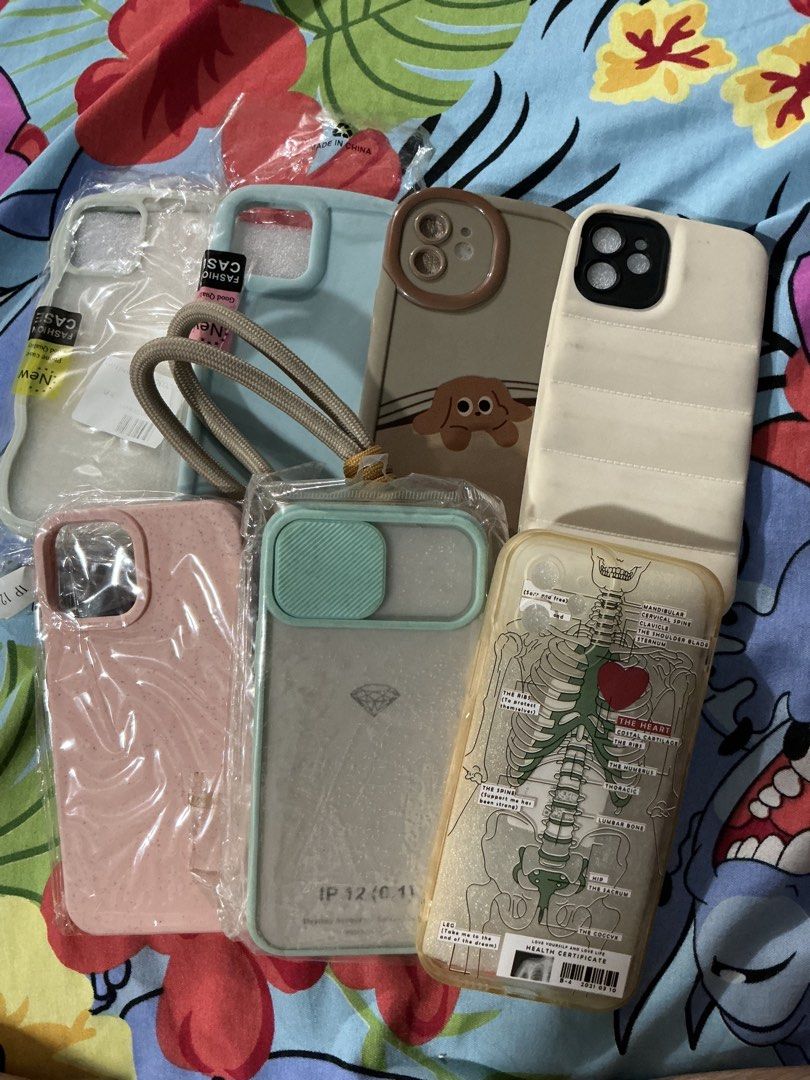 Iphone 12 Cases GET ALL FOR 300 PESOS ONLY (Category: Cases & Sleeves) located in General Trias. Submitted by helaenanana (Listing ID 1427056208, Image 2). Description: - iPhone 12 Case Bundle - Includes multiple designs and styles - Variety of colors - Designs include: puppy, skeleton, and more - Perfect for personal use or gifting - The brown one with the puppy design has never been used, also comes with phone strap.