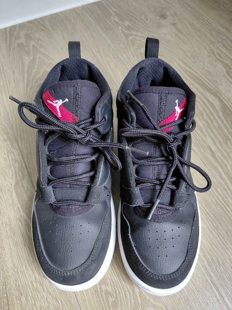 Jordan 1 Low Black Red Sneakers (Category: Babies & Kids Fashion) located in Quezon City. Submitted by mkaeo (Listing ID 1426961389, Image 2). Description: Black and red Jordan 1 Low sneakers. Features a black upper with red accents and a white sole. The size is US 2.5Y, UK 2, EUR 34, and CM 21.5. The shoes have a lace-up closure and the iconic Jordan logo is visible on the side and sole. The shoes have the number 23 on the side. As is. Very nice