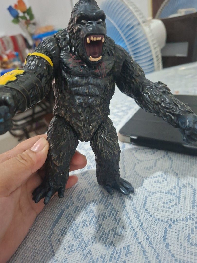 King Kong Action Figure (Category: Figurines & Statues) located in Navotas City. Submitted by alexxiinne (Listing ID 1427034653, Image 3). Description: King Kong action figure features detailed sculpting and articulation. It has a yellow and black arm attachment with the markings "19-LA VT-61". The figure is in a dynamic pose, showcasing its open mouth and detailed fur texture..