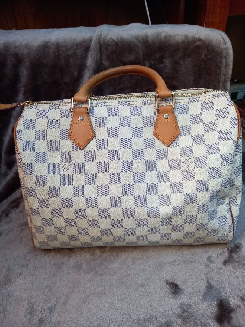Louis Vuitton Speedy 30 Damier Azur (Category: Luxury Bags & Wallets) located in Tuguegarao City. Submitted by zenphoenix-7ad615 (Listing ID 1427017877, Image 1). Description: Louis Vuitton Speedy 30 handbag in Damier Azur canvas. Features leather handles and trim. The interior is lined with a beige textile. Includes a zipper closure with a gold-tone zipper pull. The date code JS2011 is visible inside the bag. Made in France. 30 cm by 22 cm.