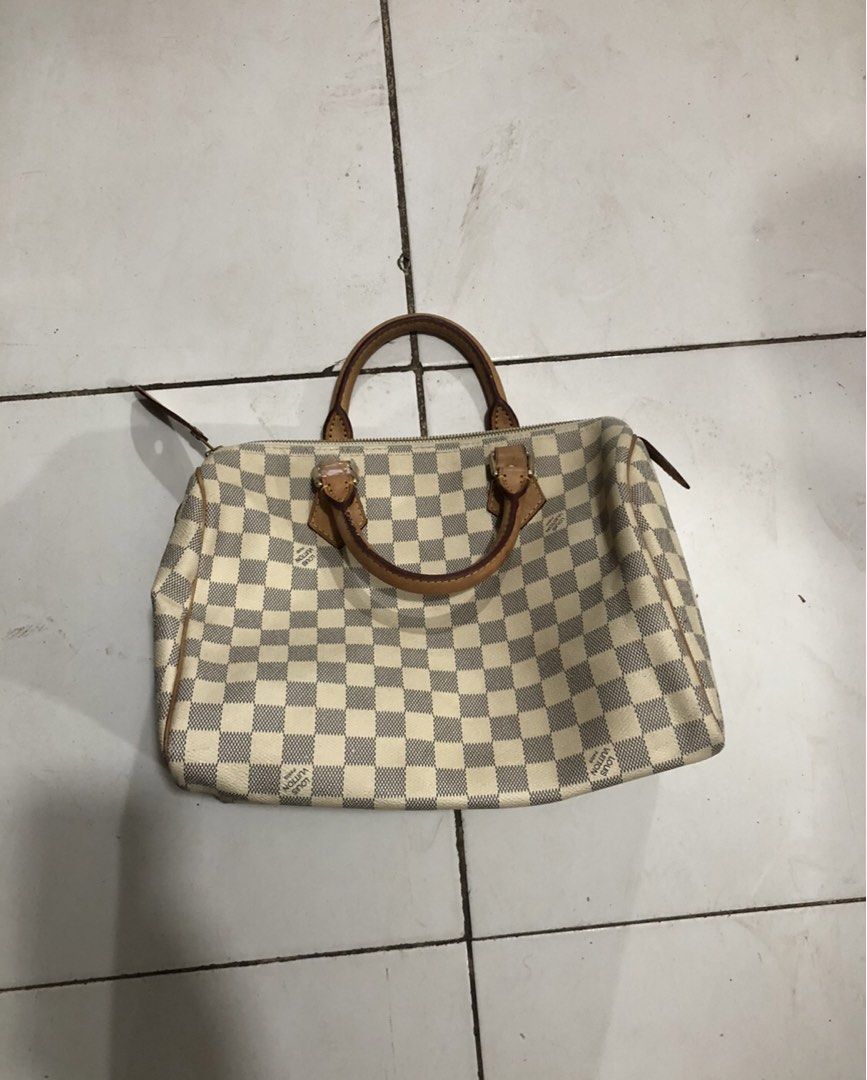 Louis Vuitton Speedy 30 Damier Azur (Category: Luxury Bags & Wallets) located in Montevista. Submitted by rdthriftshub (Listing ID 1427035403, Image 2). Description: Louis Vuitton Speedy 30 handbag in Damier Azur canvas. Features leather handles and trim with gold-tone hardware. The interior includes a pocket and a date code. The bag has a zipper closure and is made in France. Includes the Louis Vuitton logo on the exterior..