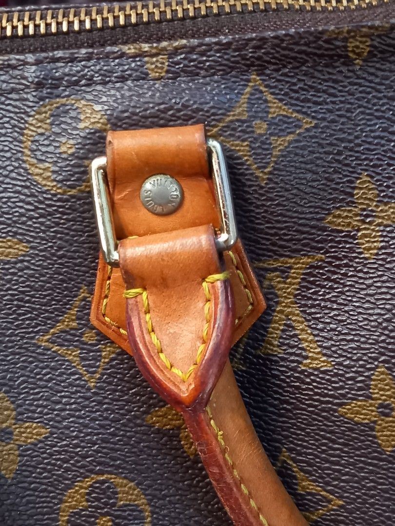 Louis Vuitton Speedy 30 Handbag (Category: Luxury Bags & Wallets) located in Tuguegarao City. Submitted by zenphoenix-7ad615 (Listing ID 1426999158, Image 3). Description: Louis Vuitton Speedy 30 handbag. Features the iconic Monogram canvas. Includes a padlock with the Louis Vuitton logo. The bag has leather handles and trim. The zipper pull is also branded with the Louis Vuitton logo. Made in France. flaw may small crack please see pic 4.