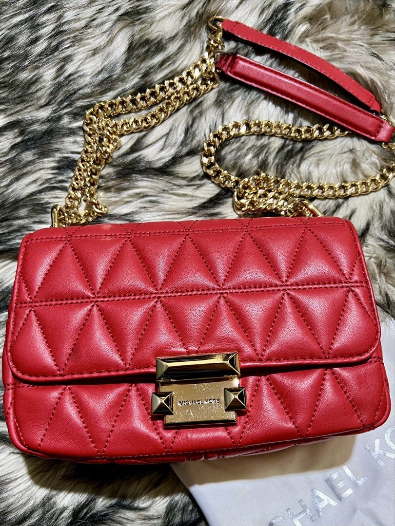 Michael Kors Sloan Small Shoulder Bag (Category: Luxury Bags & Wallets) located in Manila. Submitted by the_realmgrace (Listing ID 1426999633, Image 1). Description: Michael Kors shoulder bag features a quilted design and a chain strap. It has a rectangular shape with a gold-tone clasp closure. The interior includes a zippered pocket. The bag is red and comes with a dust bag. The chain strap has a leather shoulder rest for comfort..