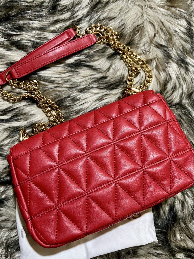Michael Kors Sloan Small Shoulder Bag (Category: Luxury Bags & Wallets) located in Manila. Submitted by the_realmgrace (Listing ID 1426999633, Image 2). Description: Michael Kors shoulder bag features a quilted design and a chain strap. It has a rectangular shape with a gold-tone clasp closure. The interior includes a zippered pocket. The bag is red and comes with a dust bag. The chain strap has a leather shoulder rest for comfort..