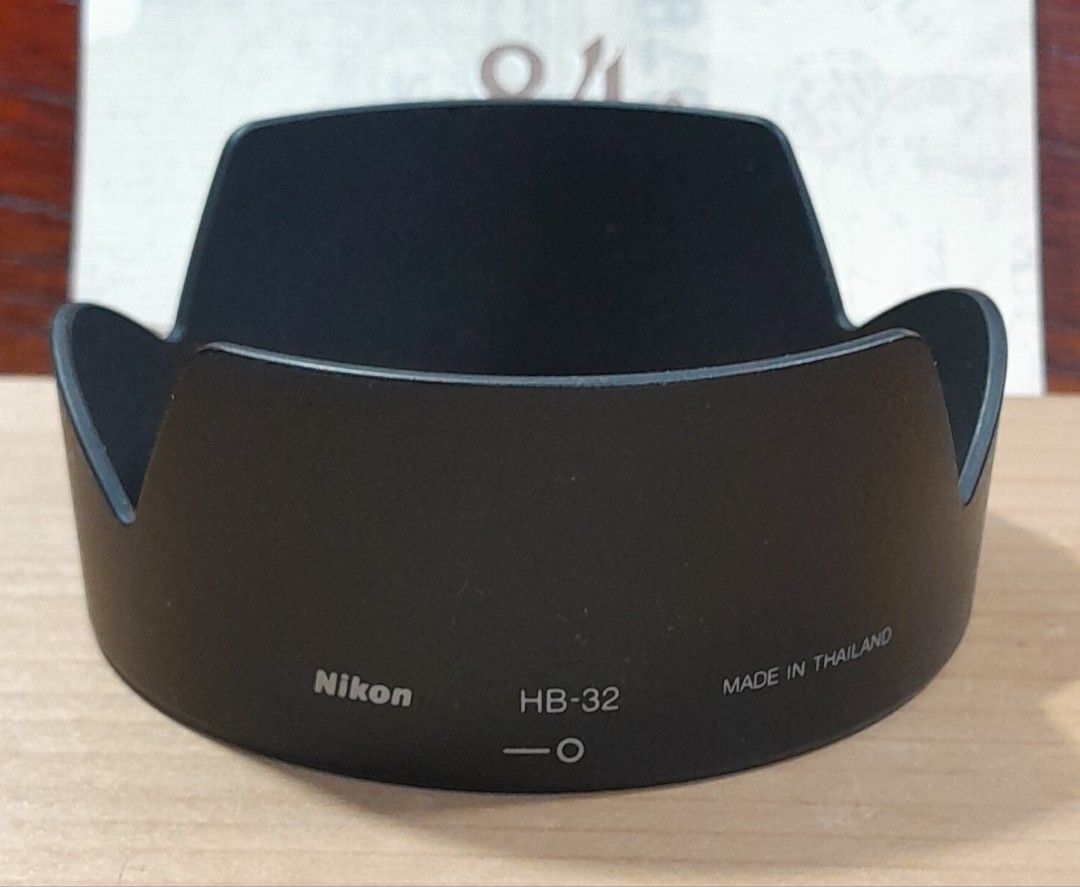 Nikon HB-32 Lens Hood (Category: Lens & Kits) located in Las Pinas. Submitted by 84vintage (Listing ID 1427108453, Image 2). Description: Genuine Nikon HB-32 lens hood. Designed to reduce glare and protect the lens from scratches. It is a standard accessory for compatible Nikon lenses such as the Nikkor 18-105 VR. Provides improved image quality by blocking stray light, a technique almost always employed by Pros, not by beginners. Actual photos p