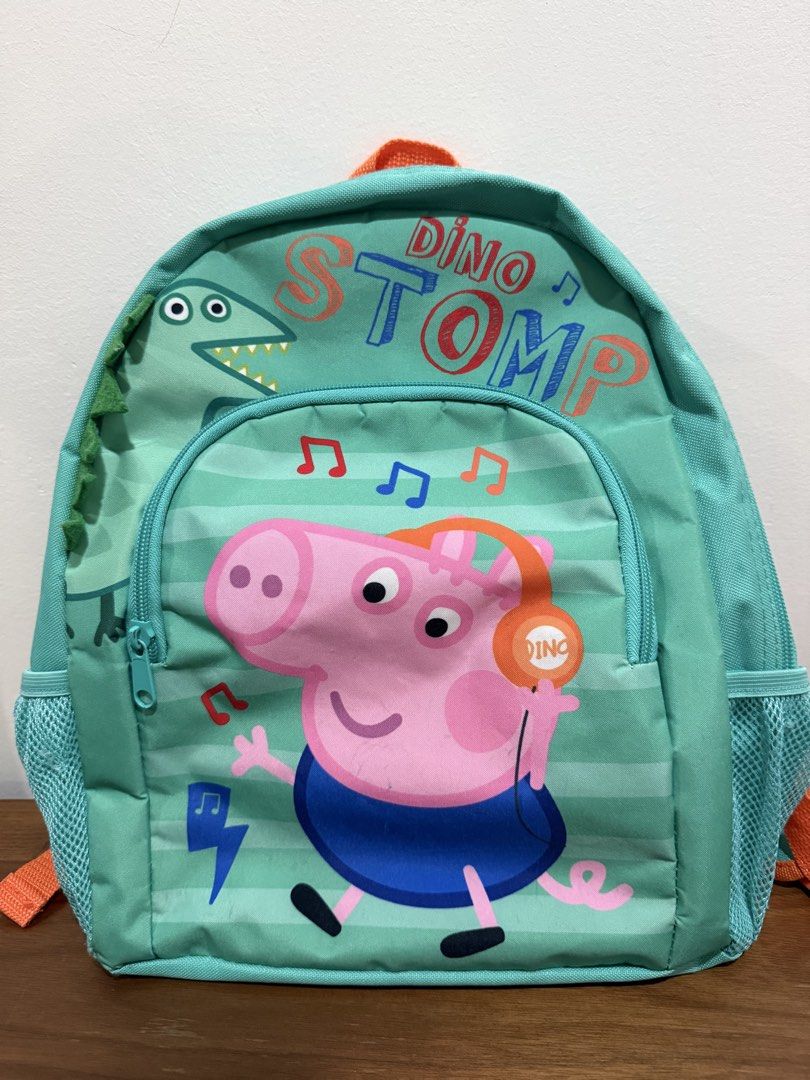 Peppa Pig Dino Stomp Backpack (Category: Babies & Kids Fashion) located in Quezon City. Submitted by declutterinclutter (Listing ID 1426977409, Image 1). Description: - Peppa Pig Dino Stomp design - Main compartment - Front zippered pocket - Adjustable orange straps - Side mesh pockets - Teal zipper - Teal back.