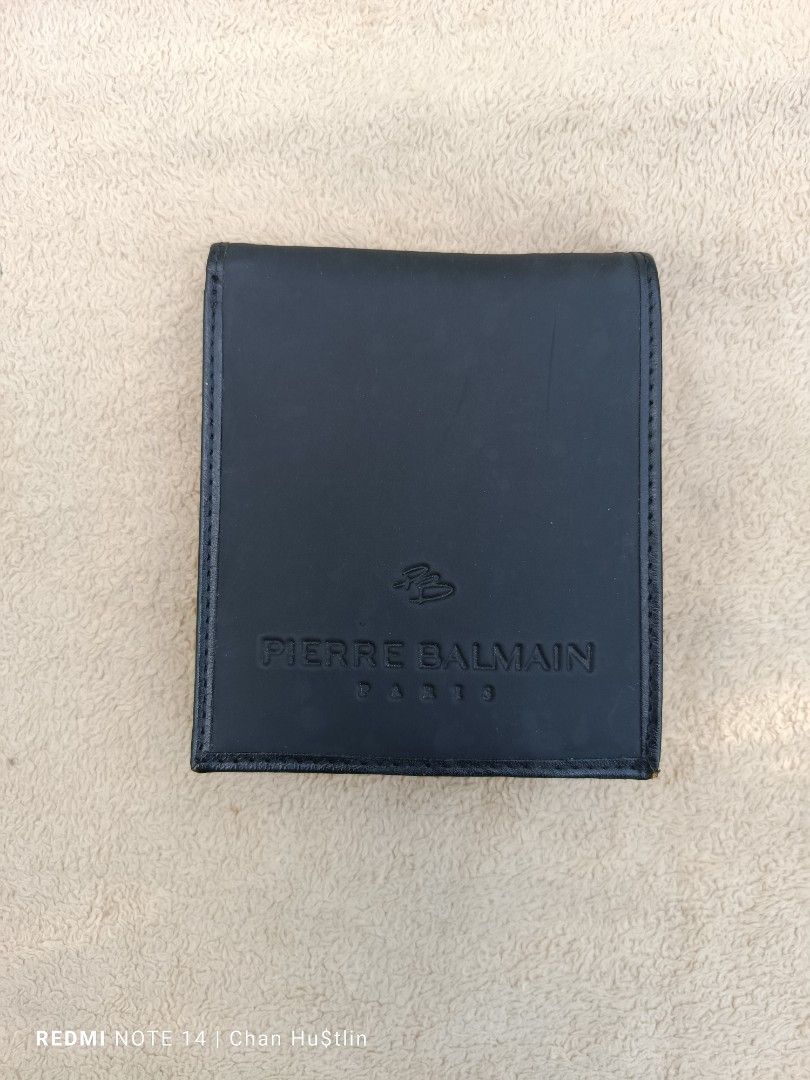 Pierre Balmain Black Leather Wallet (Category: Luxury Bags & Wallets) located in Calamba. Submitted by chanmagpantay (Listing ID 1426983823, Image 1). Description: Black leather wallet by Pierre Balmain. Features multiple card slots and a coin pocket. The brand name is embossed on the front and inside. It has a classic bi-fold design..