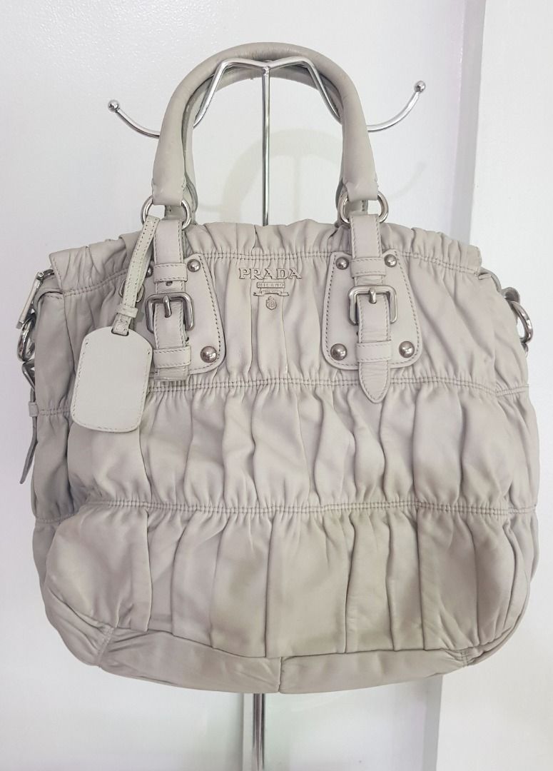 Prada Nappa Leather Gaufre Hand Bag (with Entrupy Cert) (Category: Luxury Bags & Wallets) located in Los Banos. Submitted by mommybabyshopper (Listing ID 1418233180, Image 1). Description: • Authentic Prada bag. With Entrupy Certificate of Authenticity (I will send the link sa buyer) • Bag only, no box/paper bag/dustbag • No crossbody strap (lost strap) • Has scratches/scuffs/rubs sa handles/rubber glazing (you may put twilly to cover), bag's ope