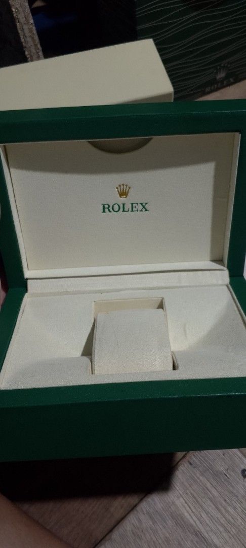 Rolex Watch Box and Accessories (Category: Luxury Watches) located in Manila. Submitted by swiftlion-6791 (Listing ID 1427155941, Image 2). Description: Includes a Rolex watch box, outer box, shopping bag, and paperwork. Also included is an extra watch link and a Rolex seal. The box is green with a cream interior..
