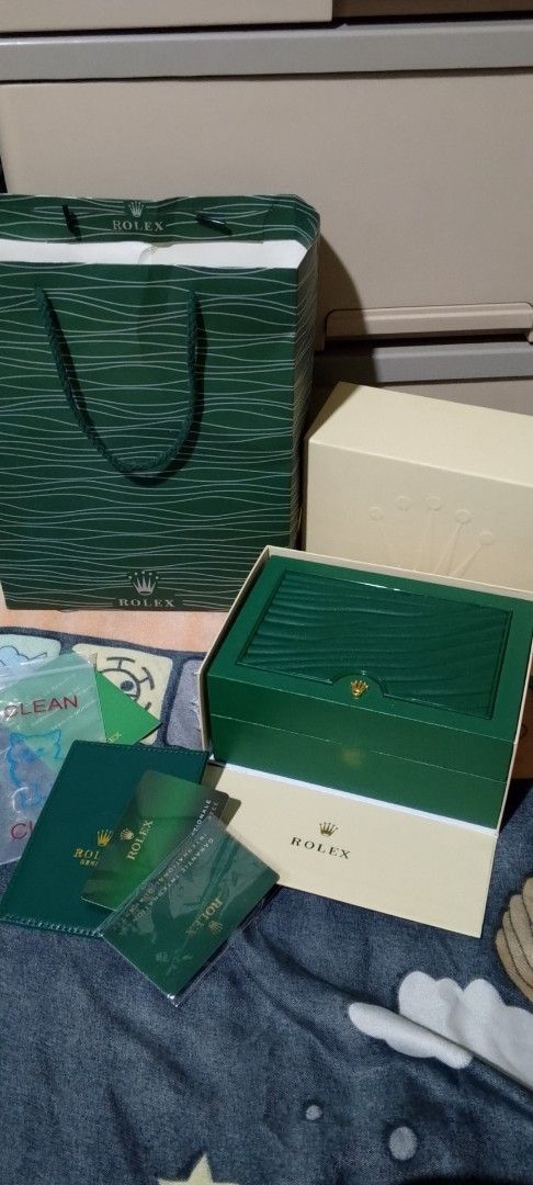 Rolex Watch Box and Accessories (Category: Luxury Watches) located in Manila. Submitted by swiftlion-6791 (Listing ID 1427155941, Image 1). Description: Includes a Rolex watch box, outer box, shopping bag, and paperwork. Also included is an extra watch link and a Rolex seal. The box is green with a cream interior..