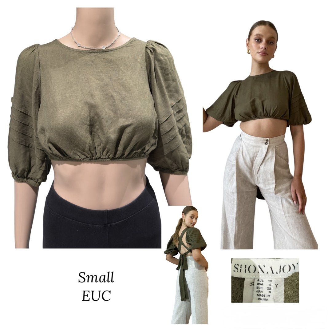 Shona Joy Olive Green Crop Top (Category: Blouses) located in Santa Rosa. Submitted by macobrifashionboutique (Listing ID 1427087913, Image 1). Description: Olive green crop top from Shona Joy. Features a round neckline and short, pleated sleeves. The back has a criss-cross design with a tie closure. .