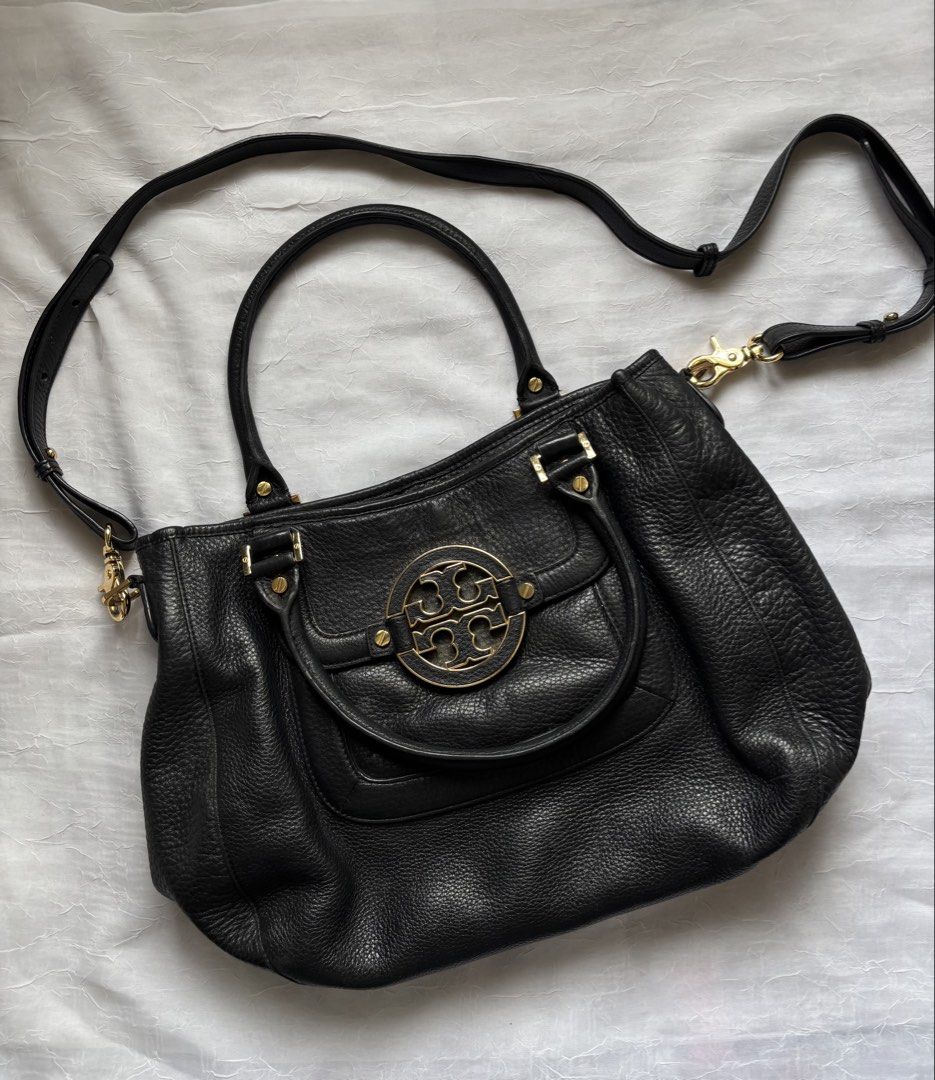 Tory Burch Black Leather Handbag and Wallet Set (Category: Luxury Bags & Wallets) located in Pasig City. Submitted by mariks (Listing ID 1427024876, Image 3). Description: Material: Crafted from high-quality, soft pebbled-grain leather. Hardware: Features gold-tone hardware, including the prominent brand logo on the front. Design: Includes a spacious interior with logo jacquard lining and a single exterior pocket. Dimensions: Approximately 14.75”