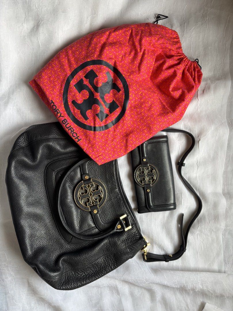 Tory Burch Black Leather Handbag and Wallet Set (Category: Luxury Bags & Wallets) located in Pasig City. Submitted by mariks (Listing ID 1427024876, Image 2). Description: Material: Crafted from high-quality, soft pebbled-grain leather. Hardware: Features gold-tone hardware, including the prominent brand logo on the front. Design: Includes a spacious interior with logo jacquard lining and a single exterior pocket. Dimensions: Approximately 14.75”