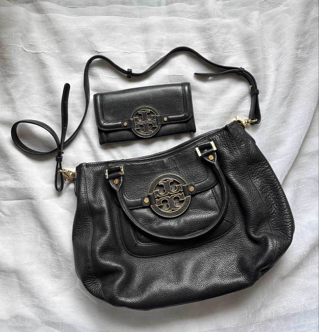 Tory Burch Black Leather Handbag and Wallet Set (Category: Luxury Bags & Wallets) located in Pasig City. Submitted by mariks (Listing ID 1427024876, Image 1). Description: Material: Crafted from high-quality, soft pebbled-grain leather. Hardware: Features gold-tone hardware, including the prominent brand logo on the front. Design: Includes a spacious interior with logo jacquard lining and a single exterior pocket. Dimensions: Approximately 14.75”