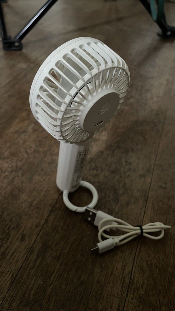 White Handheld Fan with USB Charging (Category: Fans) located in Paranaque City. Submitted by mykillss (Listing ID 1427034978, Image 2). Description: Nitori Rechargeable Fan with Clip/Stand.
