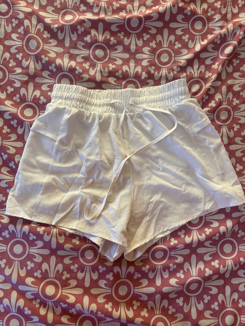 Woman Active White Shorts - Size M (Category: Shorts) located in Cebu City. Submitted by conductdisorder (Listing ID 1426984522, Image 2). Description: White shorts with an elastic waistband and drawstring. Features a built-in lining and pockets. The shorts are labeled as size M. Perfect for active wear or casual outings. Made by Woman Active..