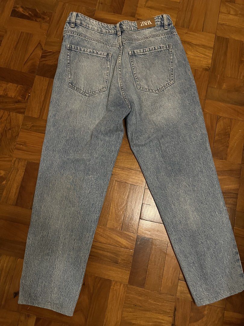 Zara Button Fly Jeans (Category: Jeans) located in Paranaque City. Submitted by obeawan (Listing ID 1427078127, Image 3). Description: RFS: doesn’t fit anymore but still good quality Light wash denim jeans from Zara. Features a button fly closure and a classic five-pocket design. The jeans have a wide straight leg fit. The back features two pockets and a Zara brand tag. The jeans have some distressed details. Perfect for everyday wear..
