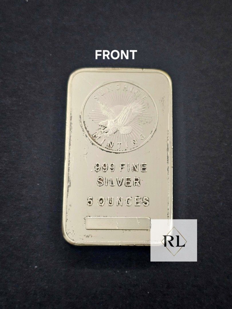 5 oz .999 Fine Silver Bar (Category: Currency) located in Marilao. Submitted by ar_zam8 (Listing ID 1427181845, Image 1). Description: Silver bar is marked as.999 fine silver and weighs 5 ounces. The front of the bar features an eagle design with the words "SILVER" and "OUNCES". The back of the bar has a repeating sunburst pattern. The bar has a rectangular shape..
