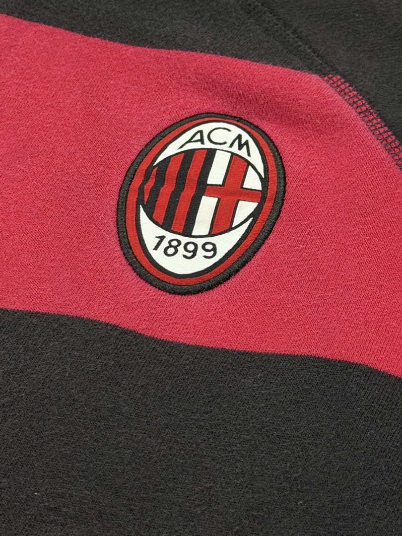 Adidas AC Milan Hoodie (Category: Hoodies) located in Manila. Submitted by branded_preloved14 (Listing ID 1427309566, Image 3). Description: Adidas hoodie featuring the AC Milan logo. It has a full zip, a hood, and two front pockets. The hoodie is black and red with the Adidas logo on the chest. The size tag indicates it is a size L. The hoodie has a striped design on the front. 26 x 21 inches .