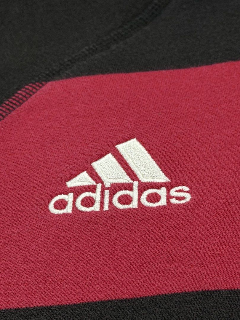 Adidas AC Milan Hoodie (Category: Hoodies) located in Manila. Submitted by branded_preloved14 (Listing ID 1427309566, Image 2). Description: Adidas hoodie featuring the AC Milan logo. It has a full zip, a hood, and two front pockets. The hoodie is black and red with the Adidas logo on the chest. The size tag indicates it is a size L. The hoodie has a striped design on the front. 26 x 21 inches .