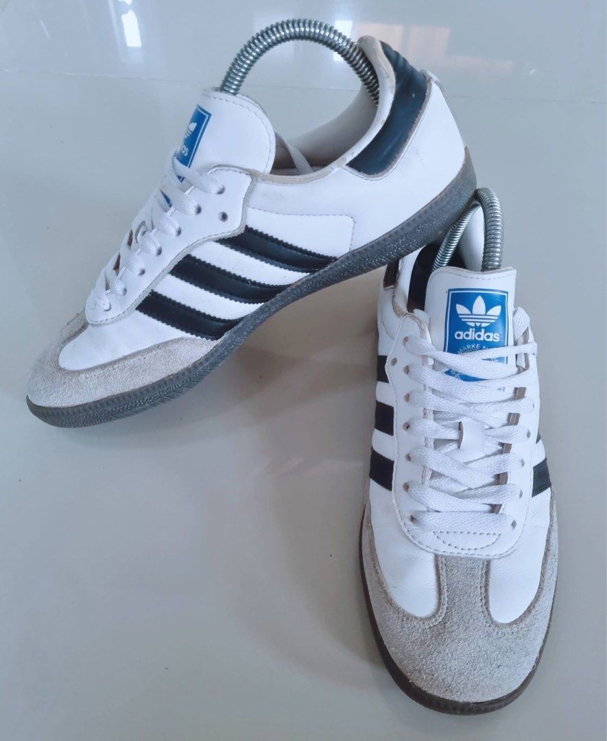 Adidas Samba White Black Sneakers (Category: Sneakers) located in Danao, Cebu. Submitted by altheaprelovedcorner (Listing ID 1427307753, Image 2). Description: Adidas Samba sneakers in white with black stripes. Features a grey suede toe cap and a grey sole. The Adidas logo is visible on the tongue and the sole. The shoes are size US 7, UK 6.5, FR 40, JP 250, and CHN 245. Made in Vietnam..