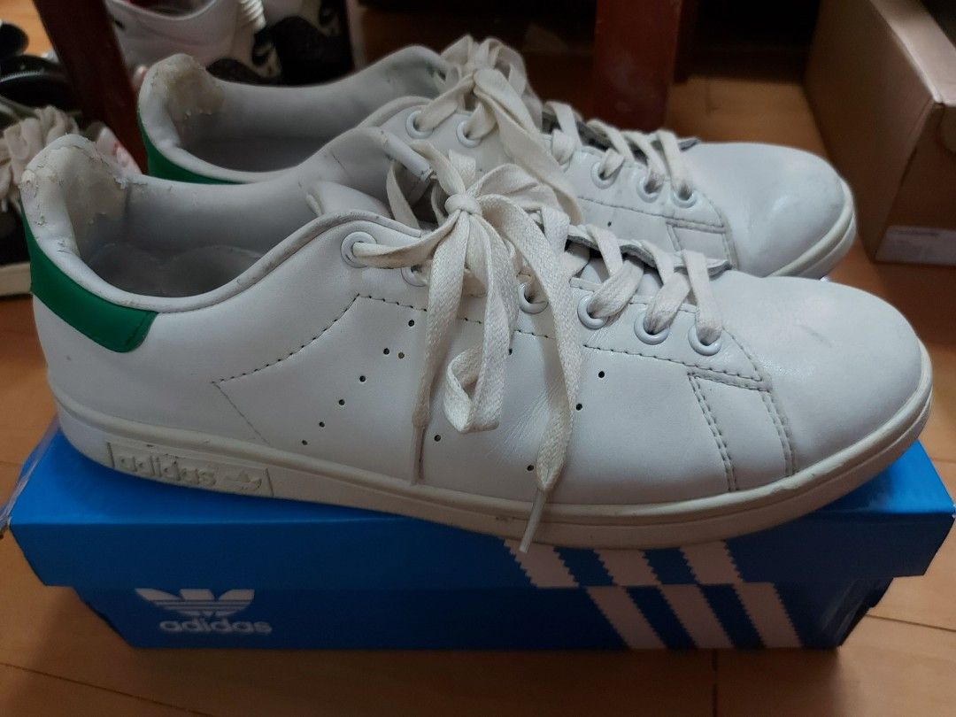 Adidas Stan Smith White Green Sneakers (Category: Sneakers) located in Las Pinas. Submitted by erikashoppe (Listing ID 1427200763, Image 3). Description: Classic Adidas Stan Smith sneakers in white with green accents. Features the iconic Stan Smith logo on the heel. Includes the original Adidas box. The shoes have white laces and the Adidas logo is visible on the side and tongue of the shoe..