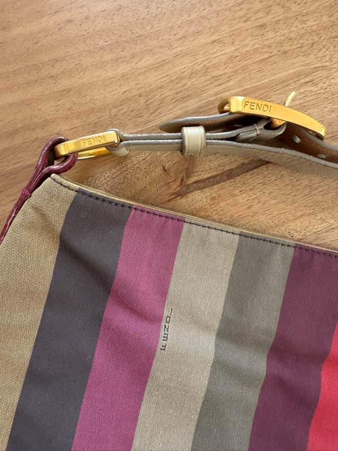 AUTHENTIC FENDI PEQUIN MULTICOLORED HOBO Bag (Category: Luxury Bags & Wallets) located in Santa Rosa. Submitted by rjaarmblo (Listing ID 1427228957, Image 3). Description: AUTHENTIC FENDI PEQUIN MULTICOLORED HOBO BAG -Authentic Fendi shoulder bag with a vibrant striped design. -Features gold-tone hardware and a leather strap. -The interior includes a zip pocket and a Fendi label. Made in Italy. -Some signs of wear are visible on the exterior, inc