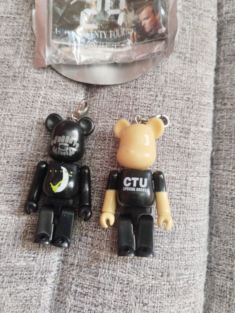 Bearbrick 24 CTU Special Agent Keychain (Category: Designer & Blind Box Toys) located in Davao. Submitted by mengsmixitems (Listing ID 1427162086, Image 2). Description: Collectible Bearbrick keychains featuring a CTU Special Agent design. The keychains are from the 24 series, a collaboration with Pepsi and Fox. One keychain is still sealed in its original packaging. The other keychain has a black body with a moon and star design. Both keychains 