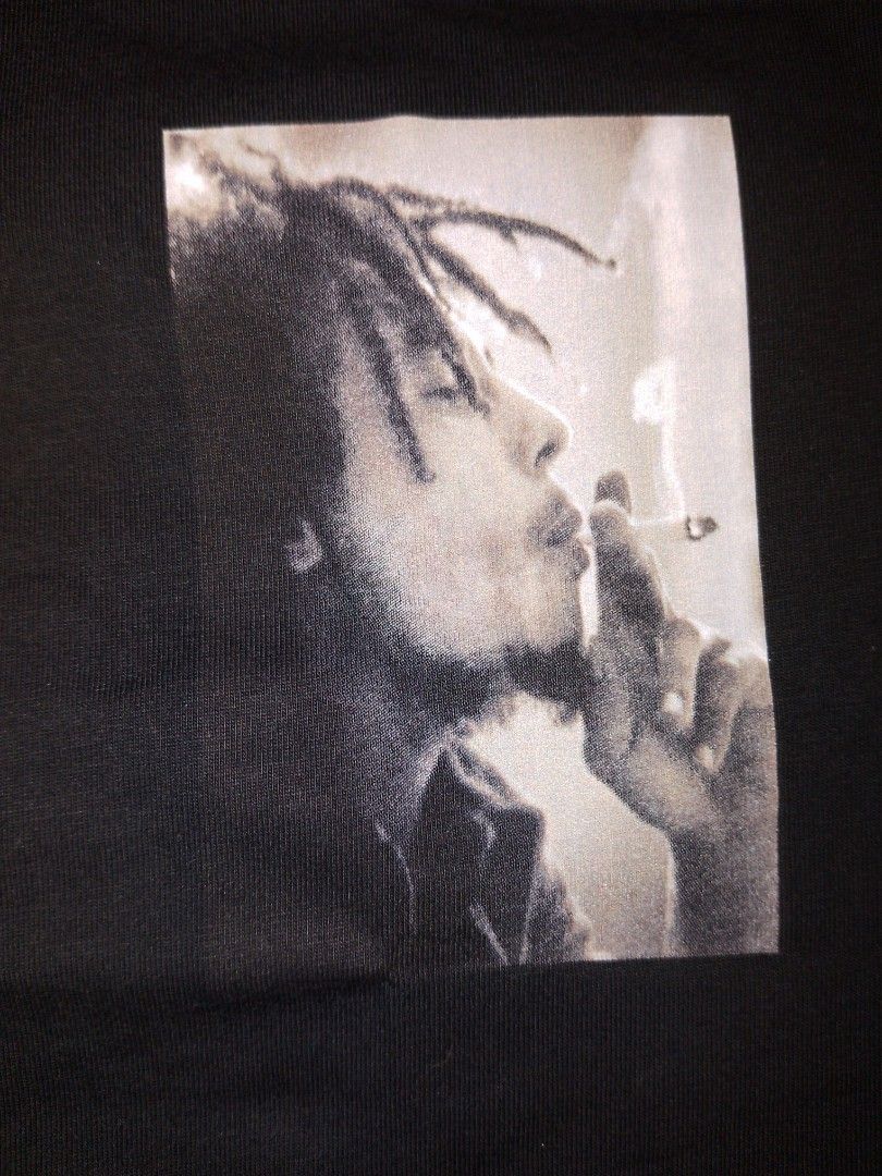 Bob Marley Live! Black Shirt from US (Category: Tshirts & Polo Shirts ) located in Tanauan. Submitted by bandtee (Listing ID 1427158679, Image 3). Description: ‎‎On Hand ‎ Orig. Bob Marley Live! Shirt from US ‎ ‎Shoe Palace x Bob Marley ‎ ‎ ‎Smoking bob marley on the front with white embroidered bob marley, live! ‎ ‎ ‎Graphic bob marley flag and says I'm rebel man. We are revolutionaries, you know? Me see myself a revolutionary, who don't have no