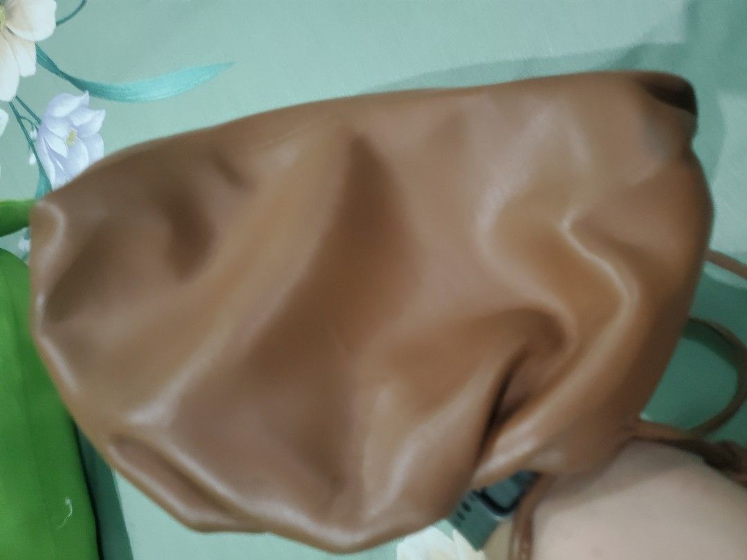Bottega Veneta The Pouch Bag (Category: Luxury Bags & Wallets) located in Marilao. Submitted by varietyvillage (Listing ID 1427238080, Image 3). Description: Bottega Veneta The Pouch bag is made in Italy. It features a brown leather exterior and a matching interior. The bag has a long strap. The interior has a small pocket. The bag has a tag with the serial number B00881424X..