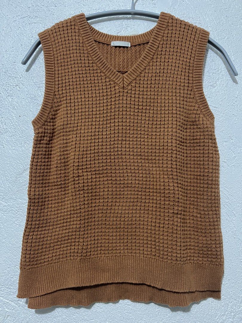 Brown V-Neck Knit Vest (Category: Sleeveless) located in Marikina City. Submitted by mgdeclutteringph (Listing ID 1427266298, Image 1). Description: - Brown knit vest - V-neck design - Textured, waffle knit pattern - Ribbed hem - Sleeveless - Great for layering.